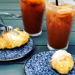 Croissants and Bloody Marys on a tabletop.