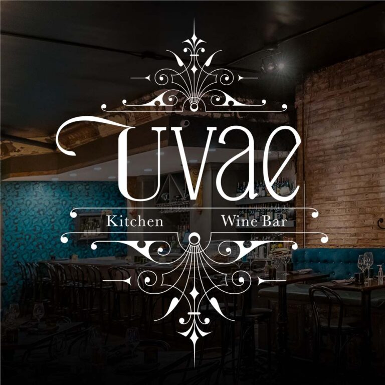 Uvae kitchen and wine bar logo in white on top of a photograph of the restaurant with a black shadowed edge.